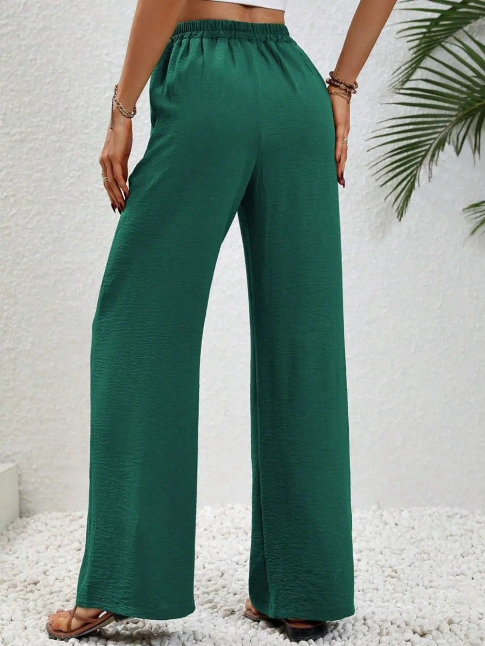 Green wide-leg drawstring pants with elastic waistband and wide straight silhouette