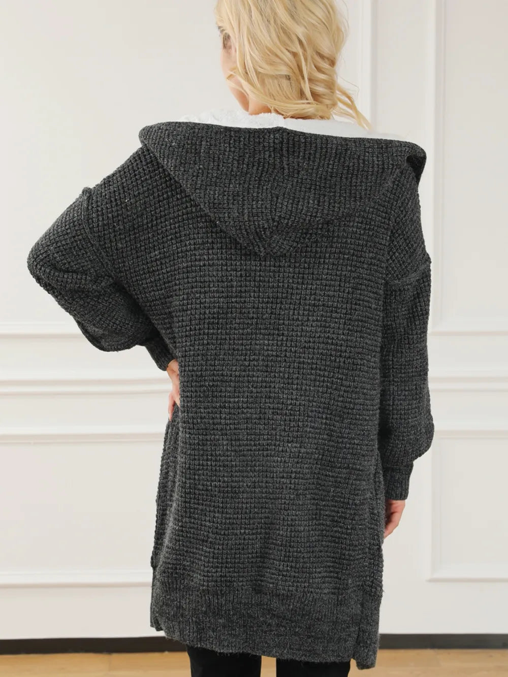 Open-front hooded winter coat with pockets, dark textured knit hood and long sleeves.