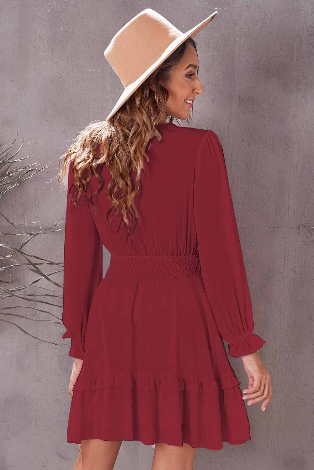 Wine red long-sleeve flounce dress with smocked waist and tiered hem, back view