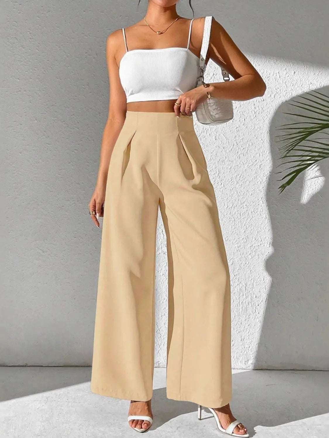 Beige high-waist wide-leg pants with pleated front and ankle-length