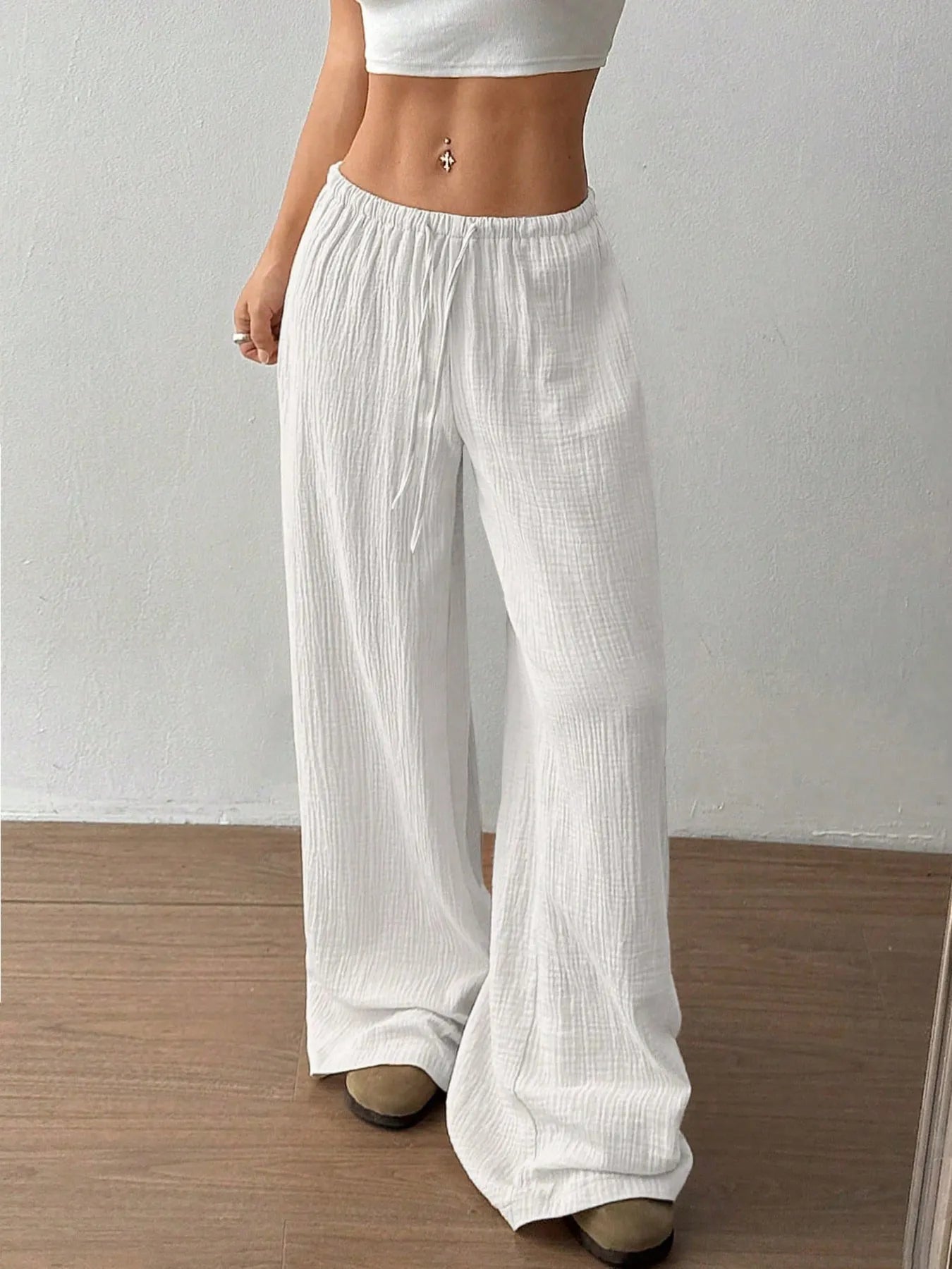 White wide-leg casual pants with elastic waistband and drawstring, full-length view.