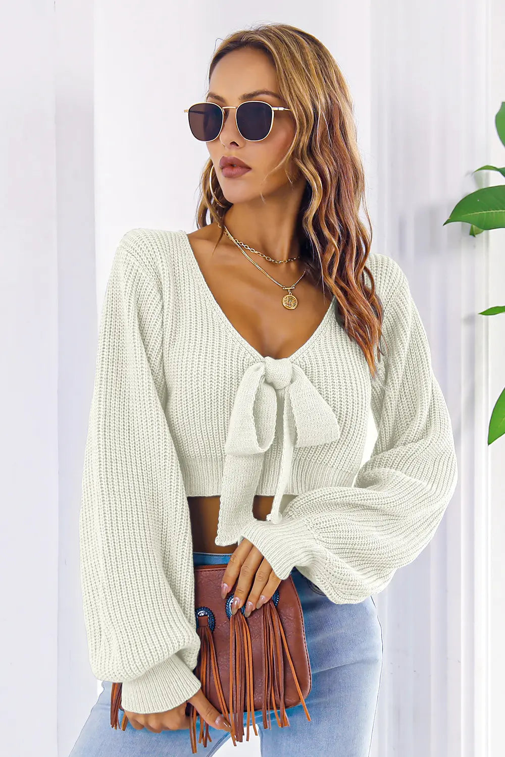 Cream knit bow V-neck cropped sweater, back view with long sleeves