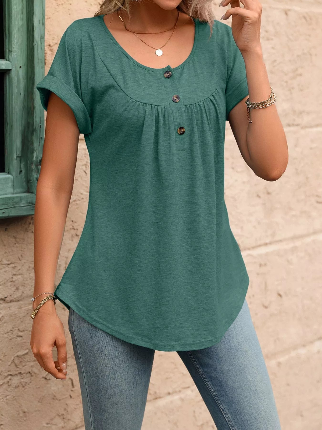 Green short-sleeve henley top with button placket and gathered neckline