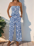 Blue smocked tube wide-leg jumpsuit with navy circular medallion print