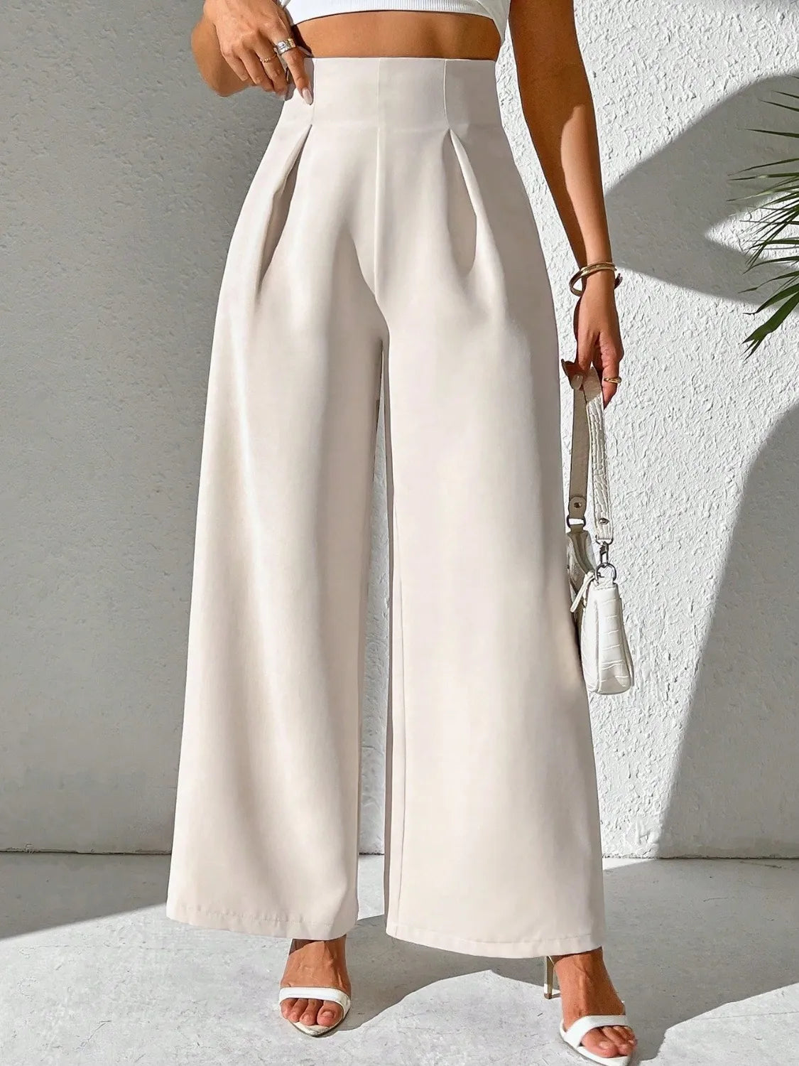 Beige wide-leg high-waist pants with pleated front and straight wide legs