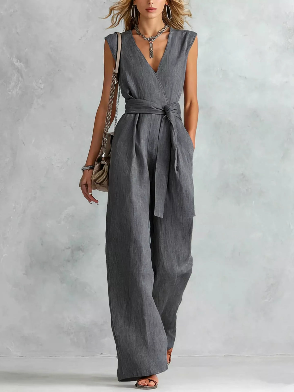 Dark gray sleeveless wide-leg jumpsuit with V-neck and tied waist
