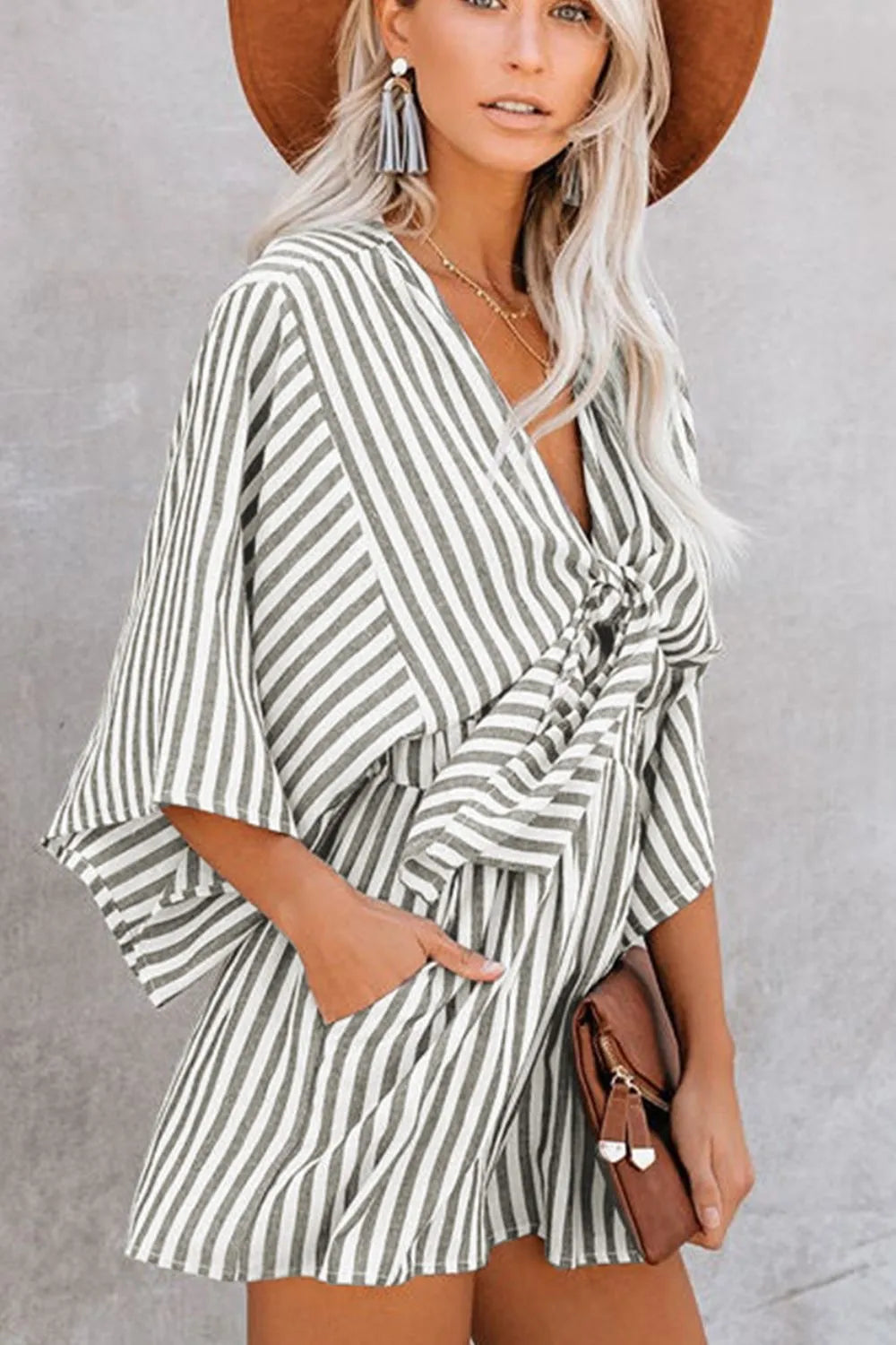 Striped kimono-sleeve romper with V neckline and front bow-tie detail, vertical stripes