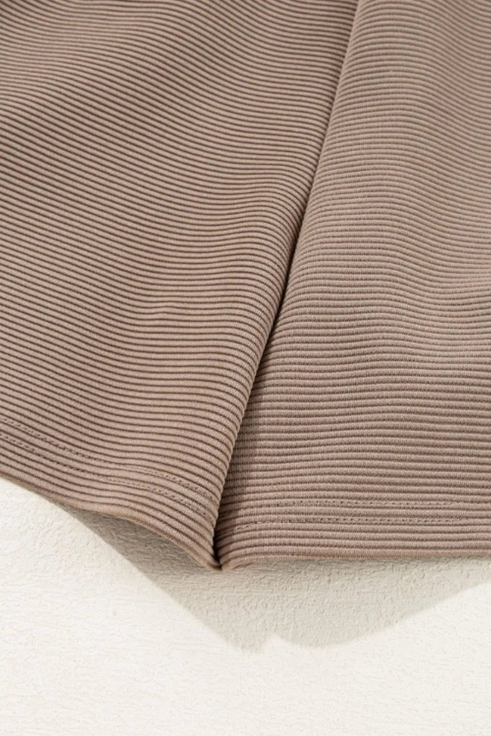 Mocha textured romper fabric with pleated hem and elastic waist finish
