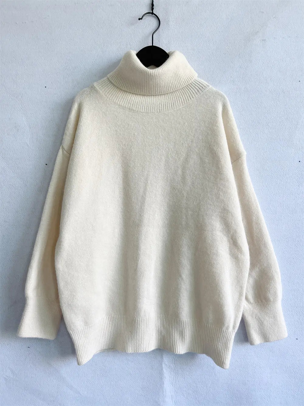 Cream turtleneck long-sleeve sweater with ribbed collar and cuffs