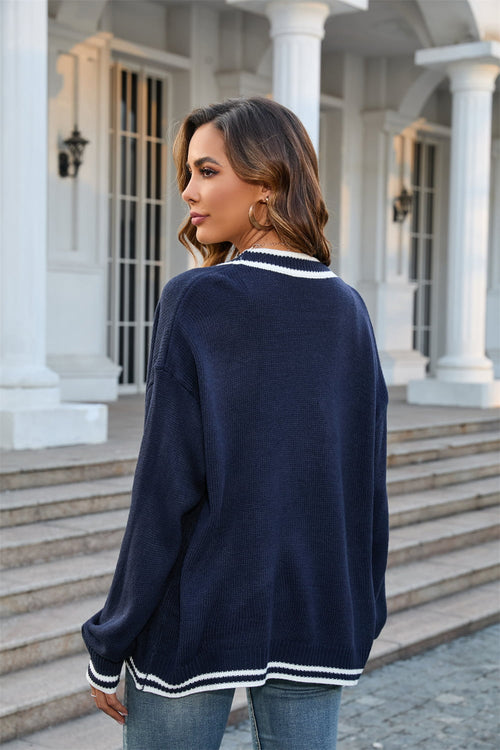 Dark blue cardigan back view with contrast striped hem and cuffs