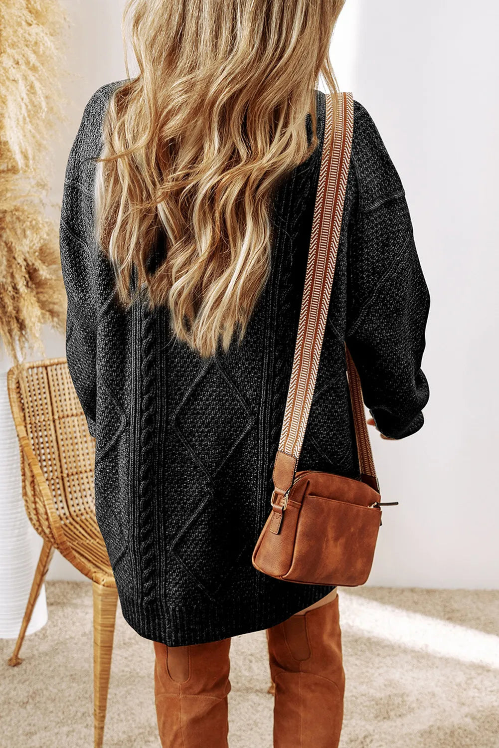 Black cable-knit round-neck sweater dress with cable pattern and long sleeves, back