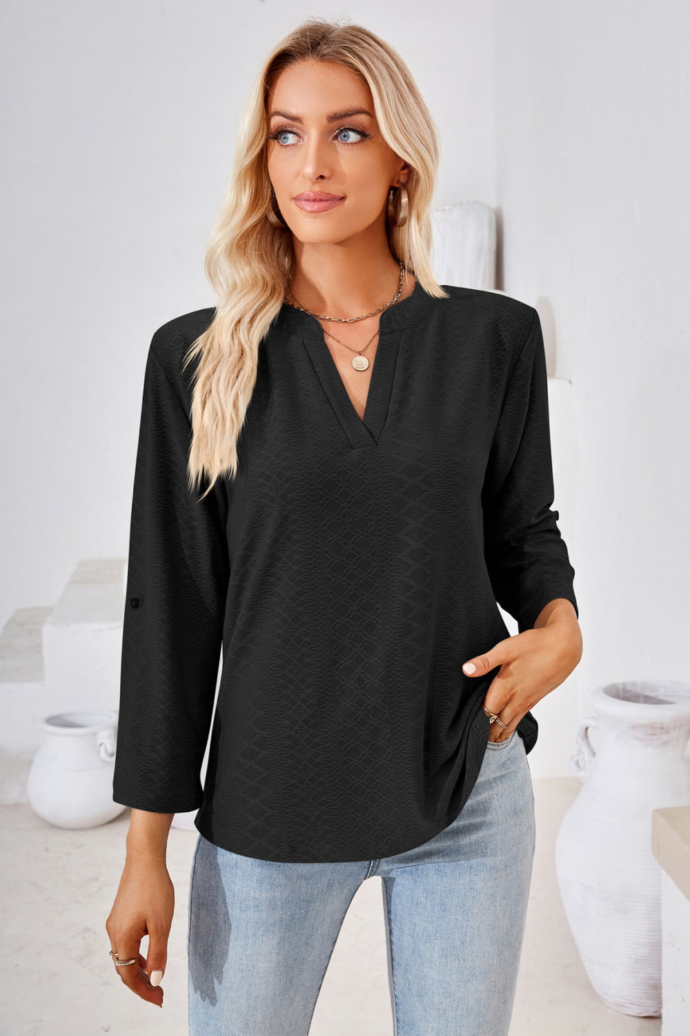 Black V-neck blouse with 3/4 roll-tap sleeves