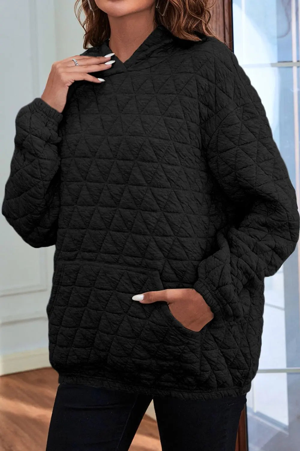 Black quilted long-sleeve hoodie with hood and front kangaroo pocket