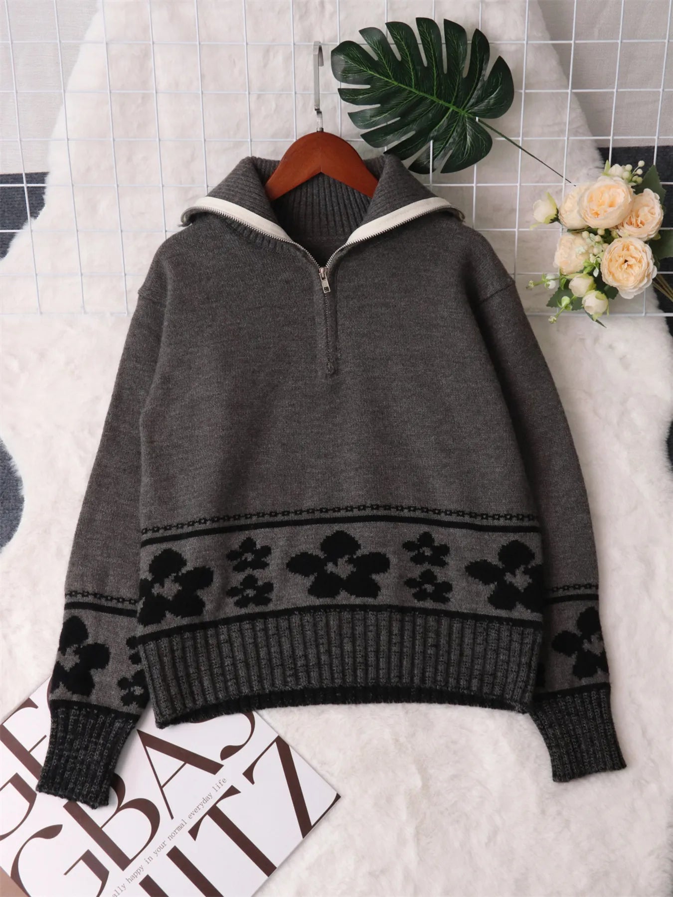 Gray zip-collar sweater with black floral stripe band across the sleeves and hem