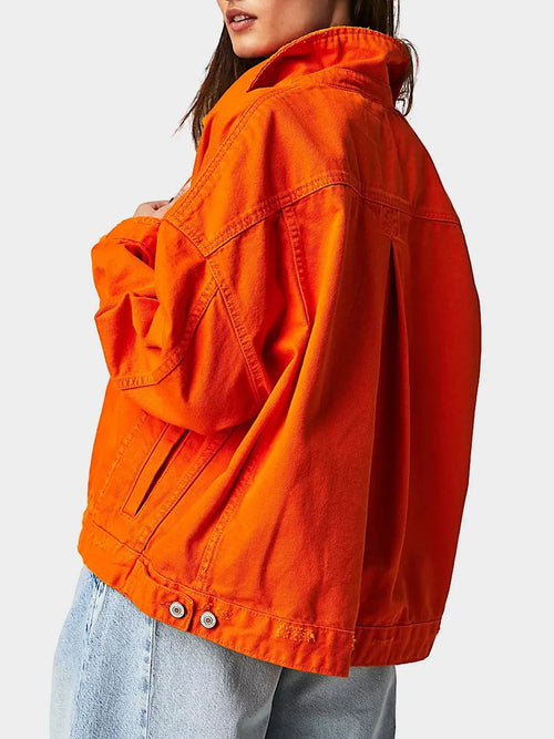 Orange long-sleeve denim jacket, side view with buttoned cuffs and flap pocket