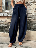 Dark blue elastic-waist pants with side pockets, relaxed wide-leg fit