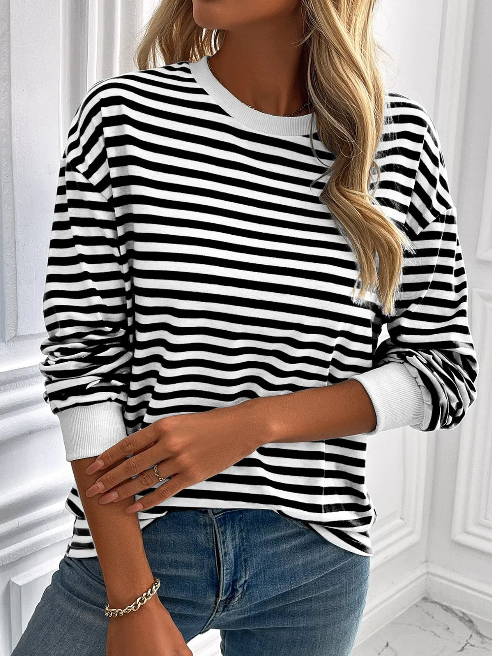 Striped crewneck long-sleeve sweatshirt in black and white, long sleeves shown