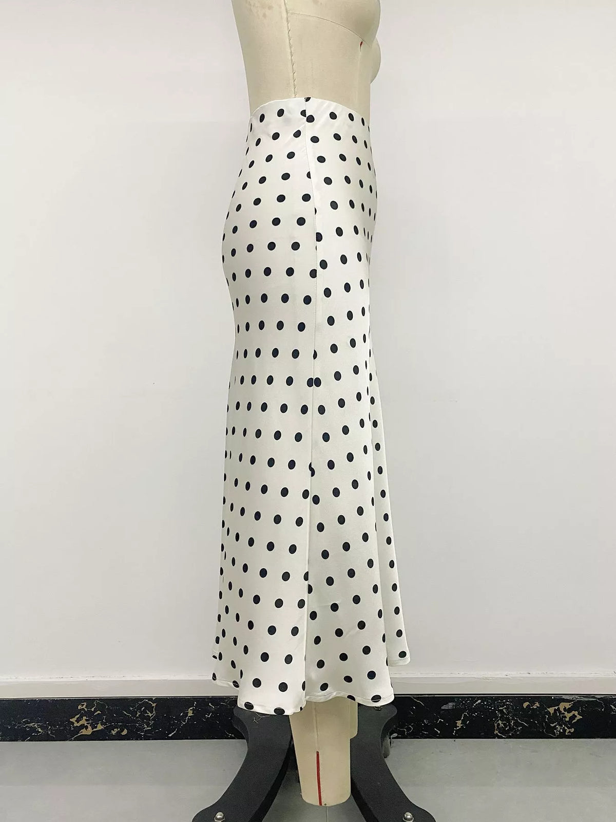 Beige polka dot stretch midi skirt on mannequin, side profile view
