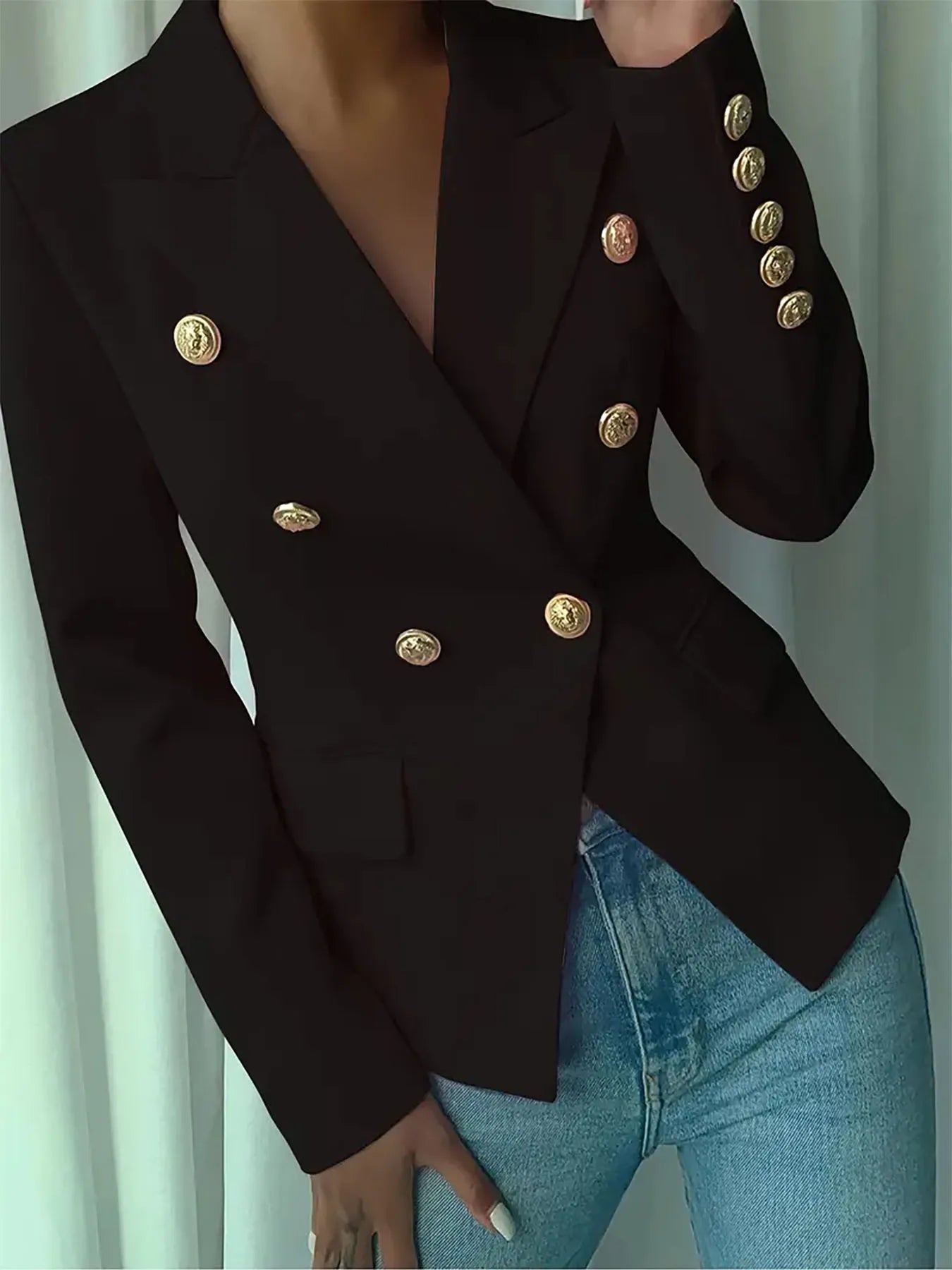 Black lapel blazer with gold-tone decorative buttons; deep V neckline and long sleeves