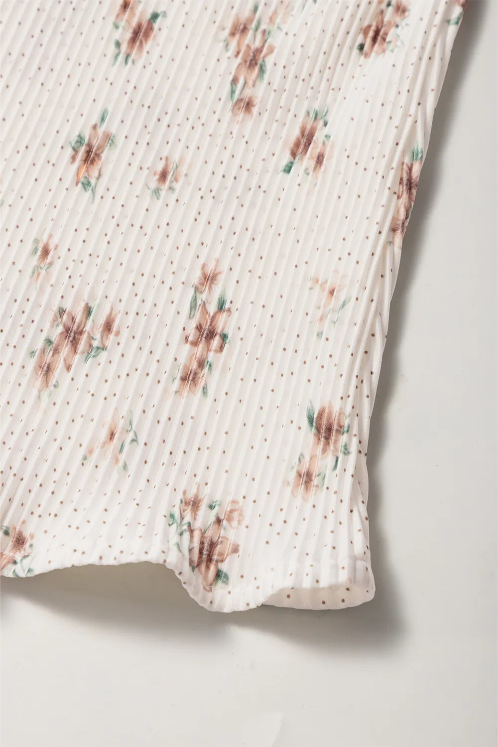 Floral printed cami fabric with gathered hem; white base with small floral motifs