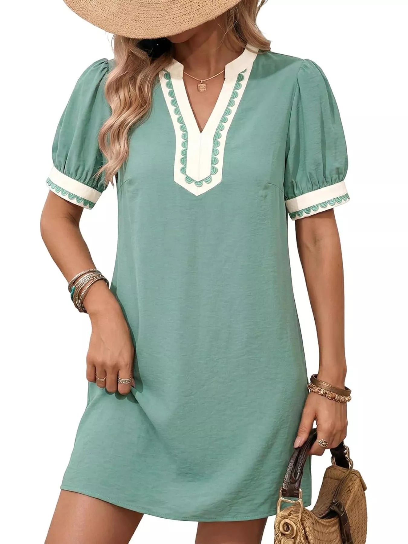 Teal mini dress with notched V neckline and puff sleeves, white trim on collar and cuffs.