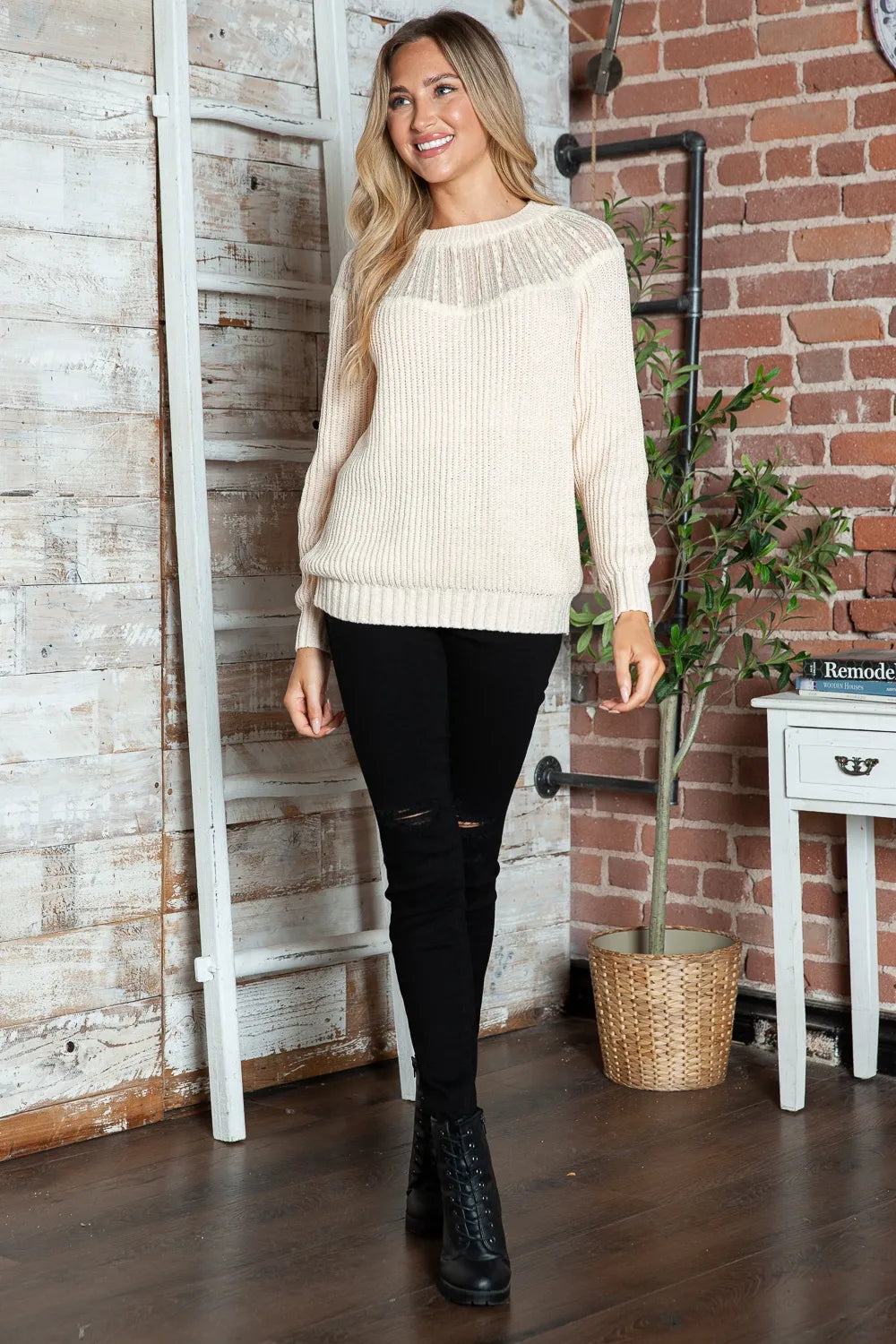 Cream round-neck rib-knit sweater with long sleeves and ribbed cuffs, relaxed fit