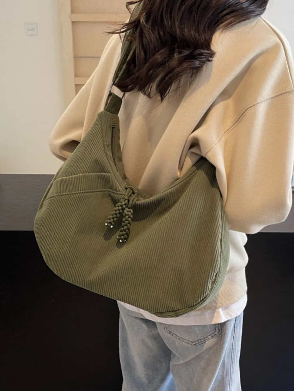 Moss green ribbed shoulder bag with adjustable strap and drawstring top