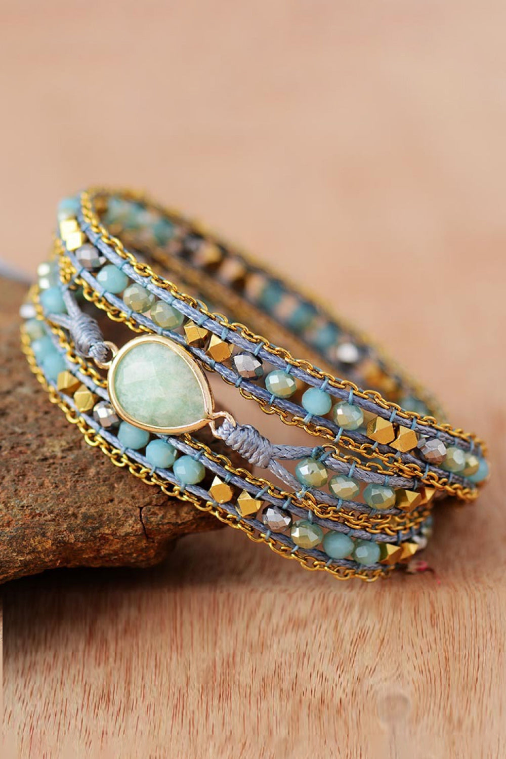 Aqua triple-layer beaded bracelet, side view with teardrop stone pendant