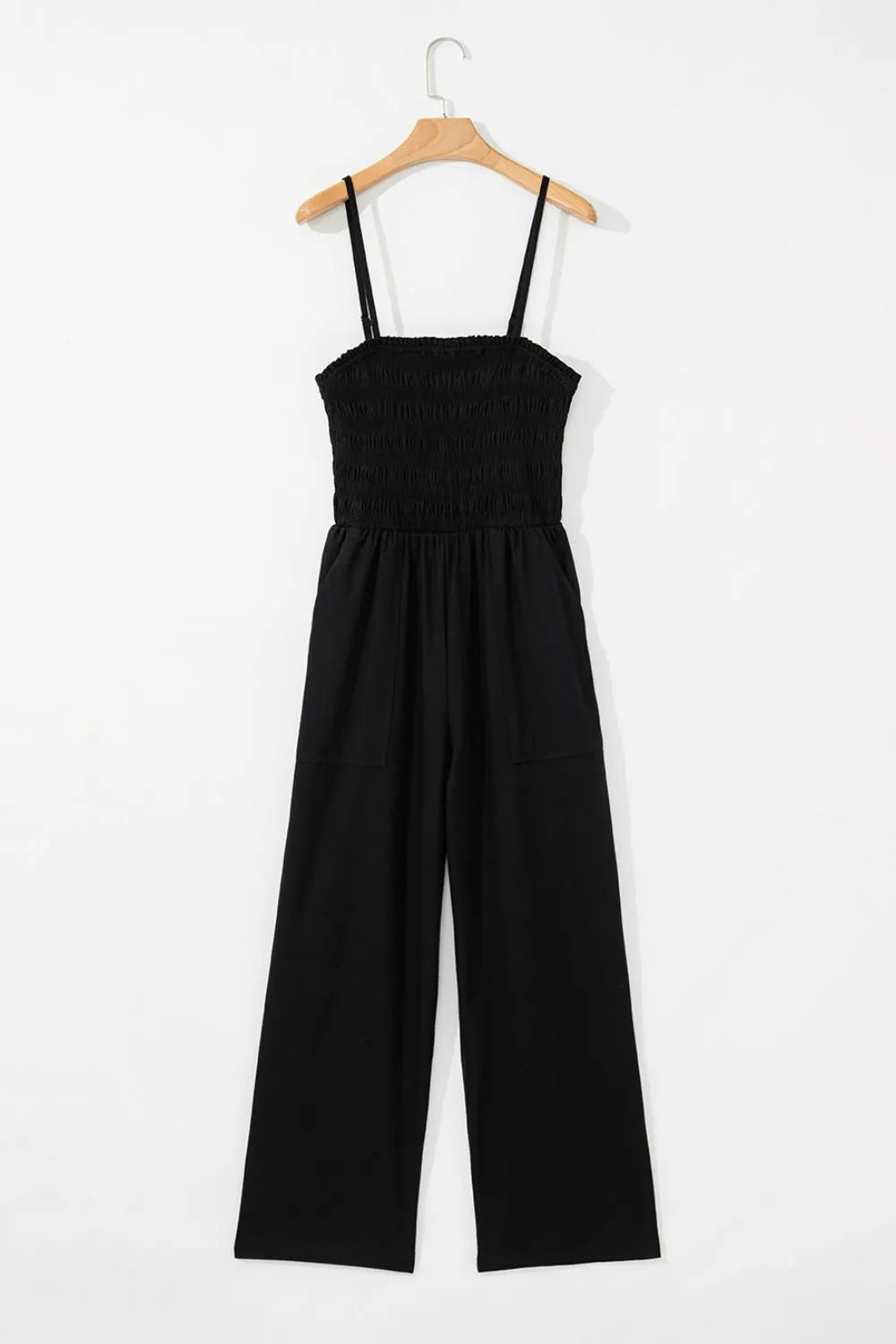 Black smocked spaghetti strap wide-leg jumpsuit on a hanger, front view