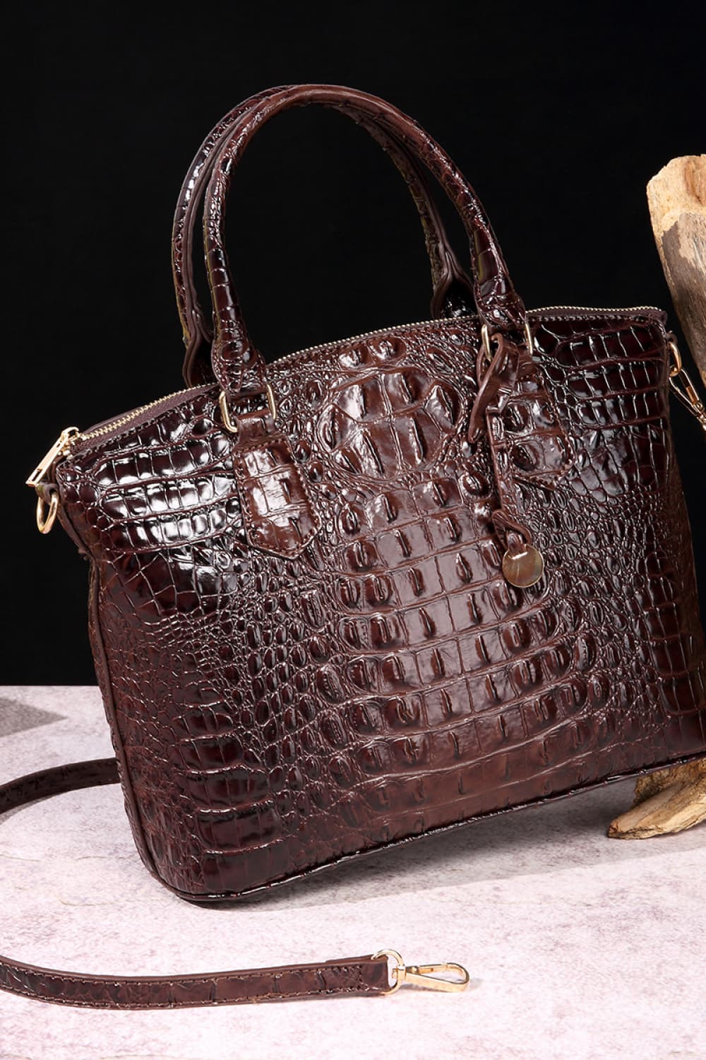 Dark brown croc-embossed handbag with top handles and gold-tone hardware