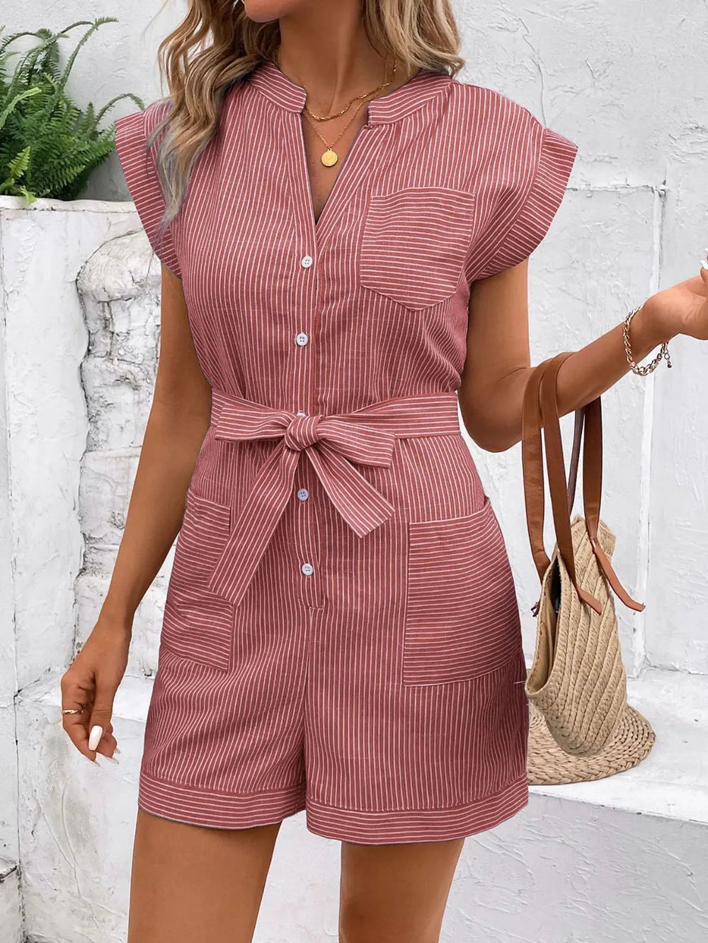 Striped notched tie-waist romper in dusty pink, front view with collar and bow at waist
