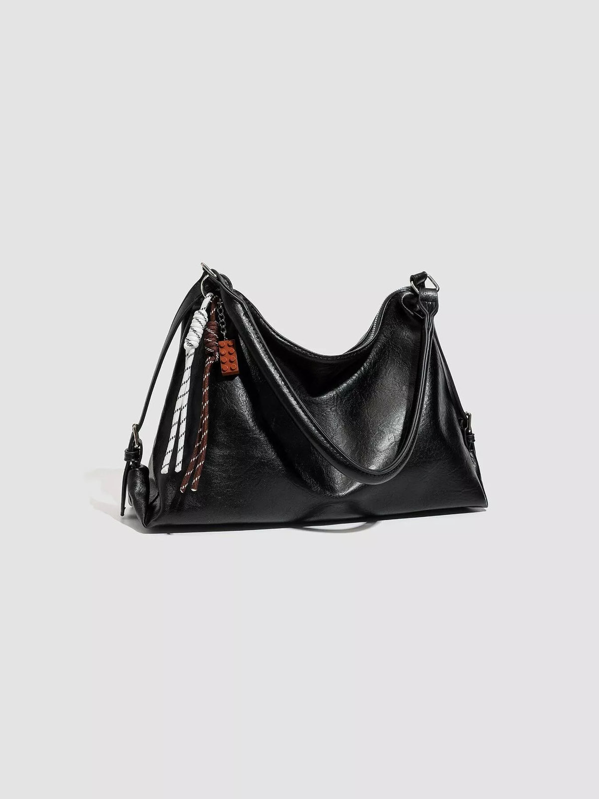 Black hobo shoulder bag with top zip and braided strap trim