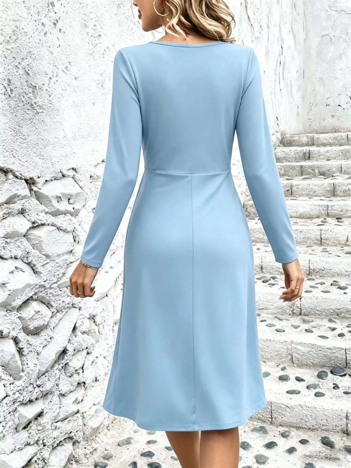 Light blue back view ruched surplice long-sleeve midi dress with center seam