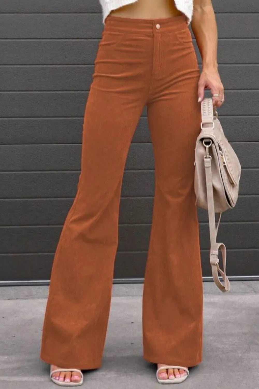 High-waist bootcut pants in rust orange with front button and side pockets