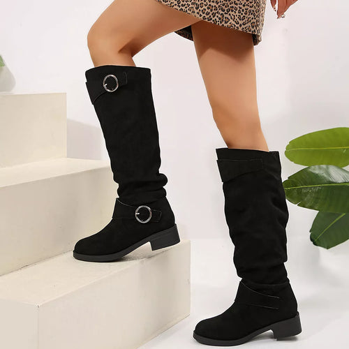 Black buckle slouch boots with round metal rings and block heel.