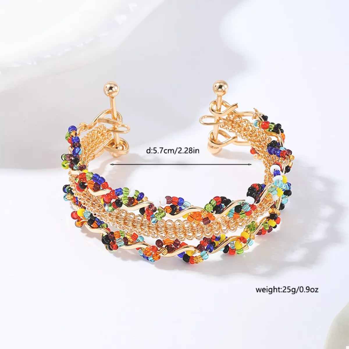 Three-row gold-tone open bracelet with colorful bead accents, side view with clasp