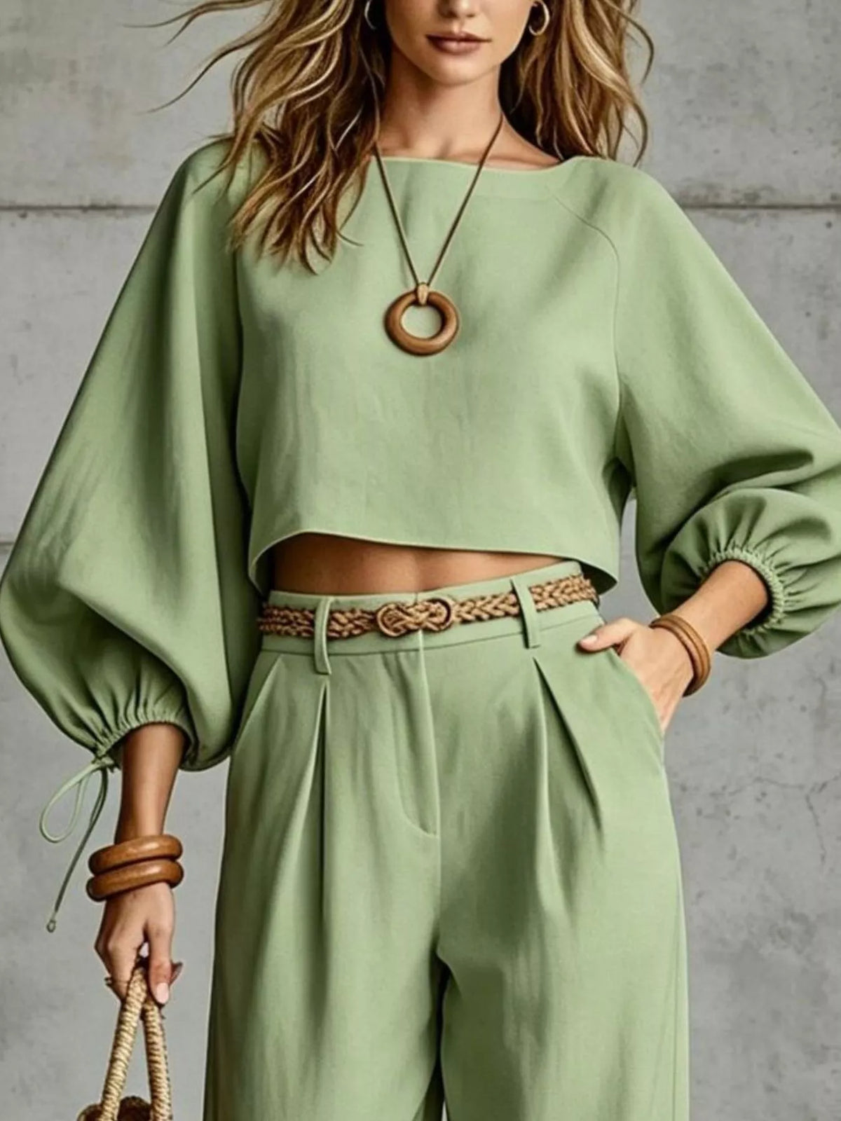 Sage green balloon-sleeve crop top with embroidered waist belt and wide-leg pants