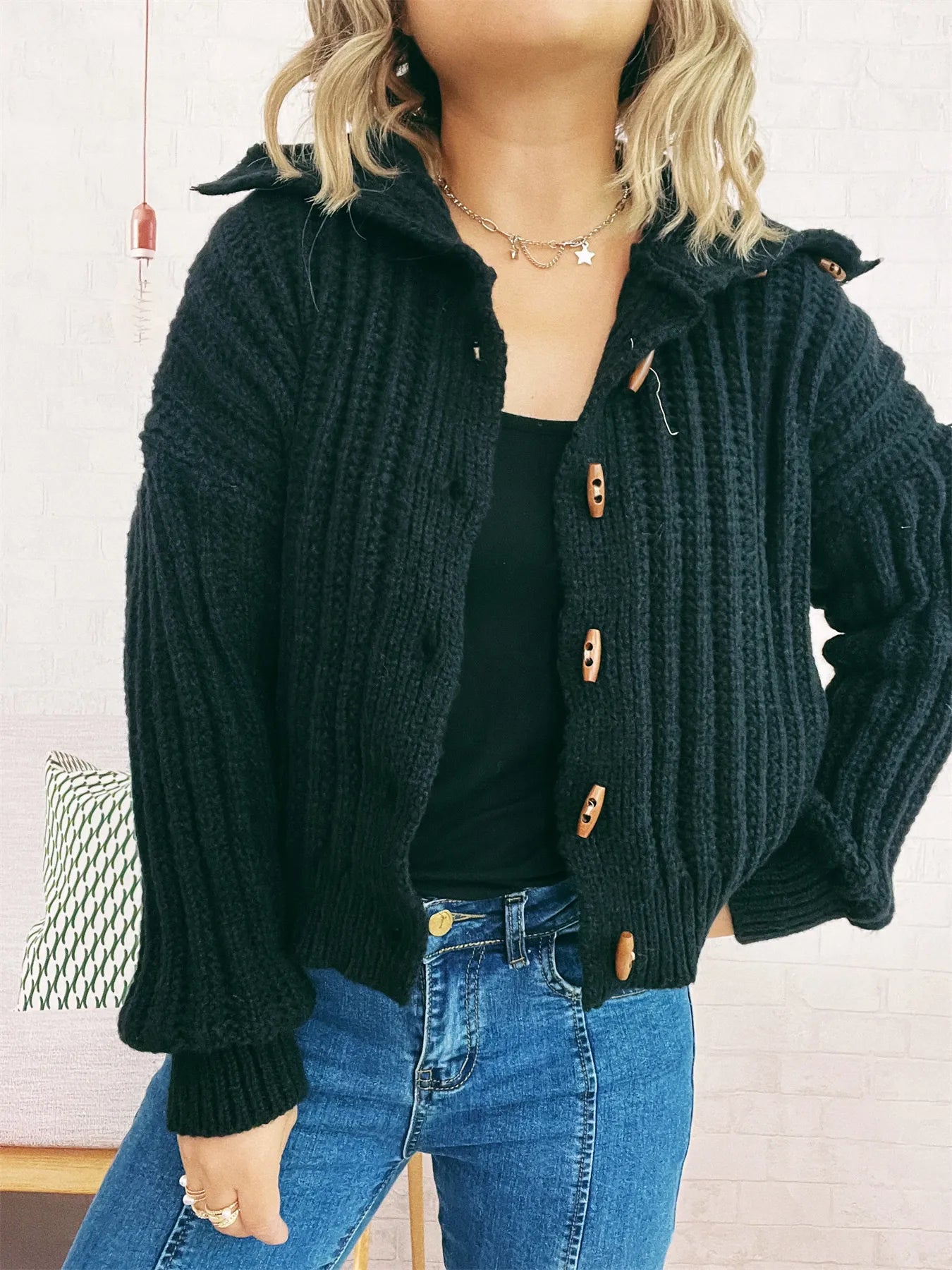 Dark green button-up long-sleeve cardigan with ribbed knit and brown button placket, front view