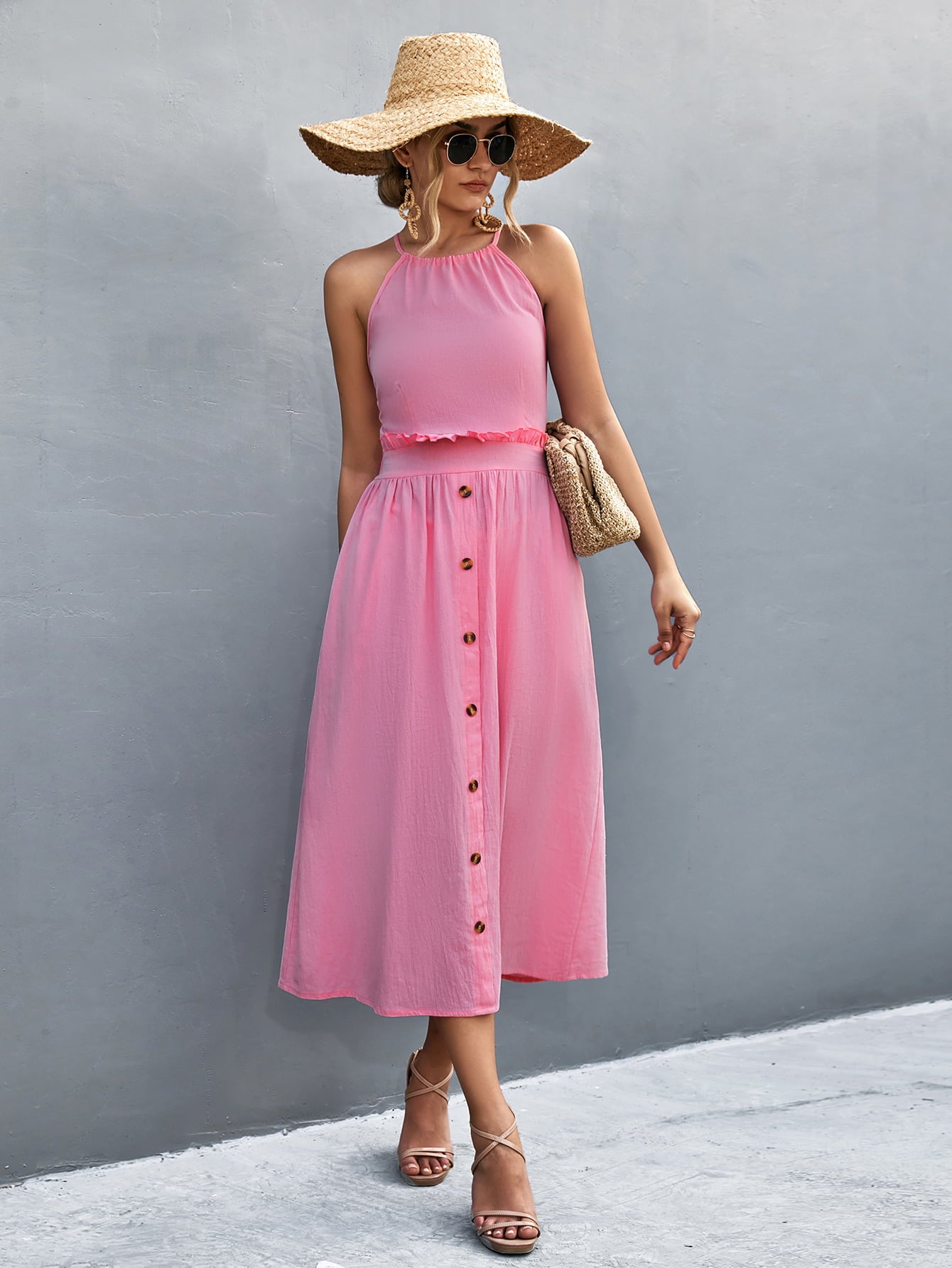 Pink halter neck midi dress with frill trim and button-front skirt.