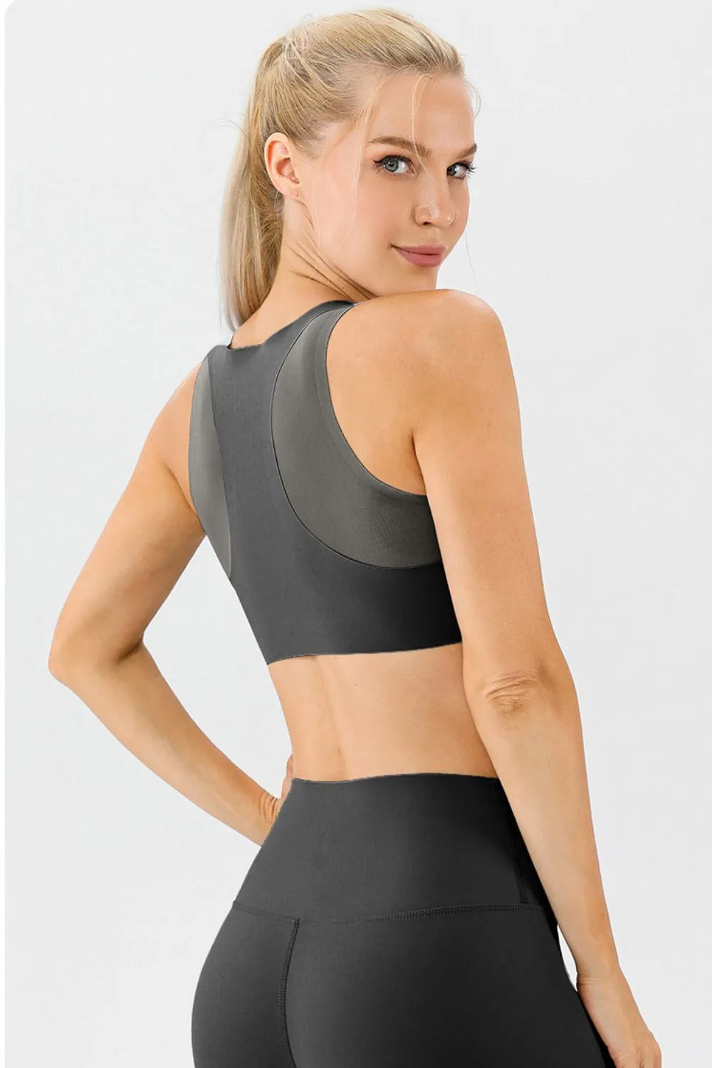 Black active bra with wide straps and round back cutout, side-back view