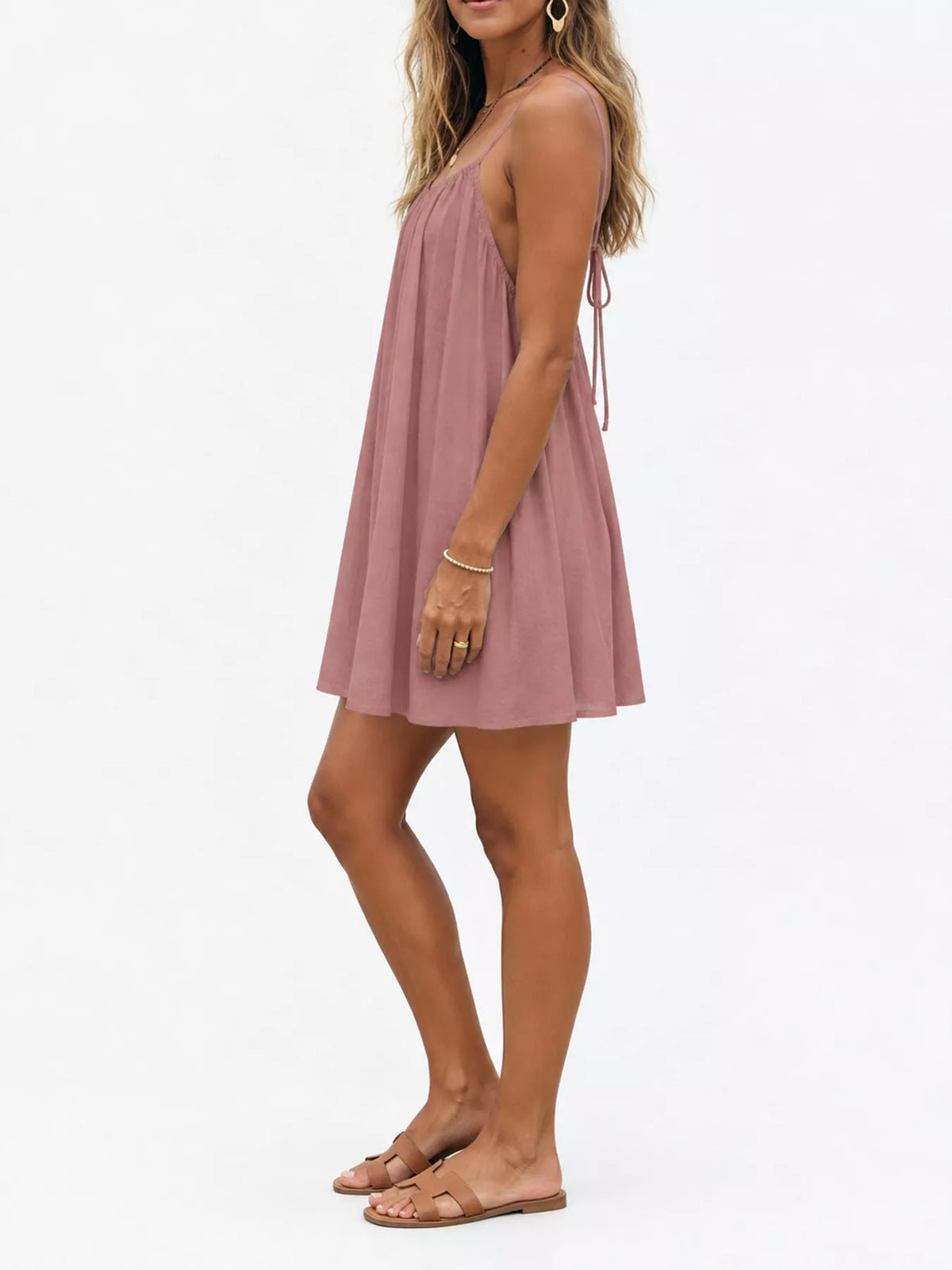 Backless spaghetti-strap ruched mini dress in dusty mauve, A-line skirt and thin straps.