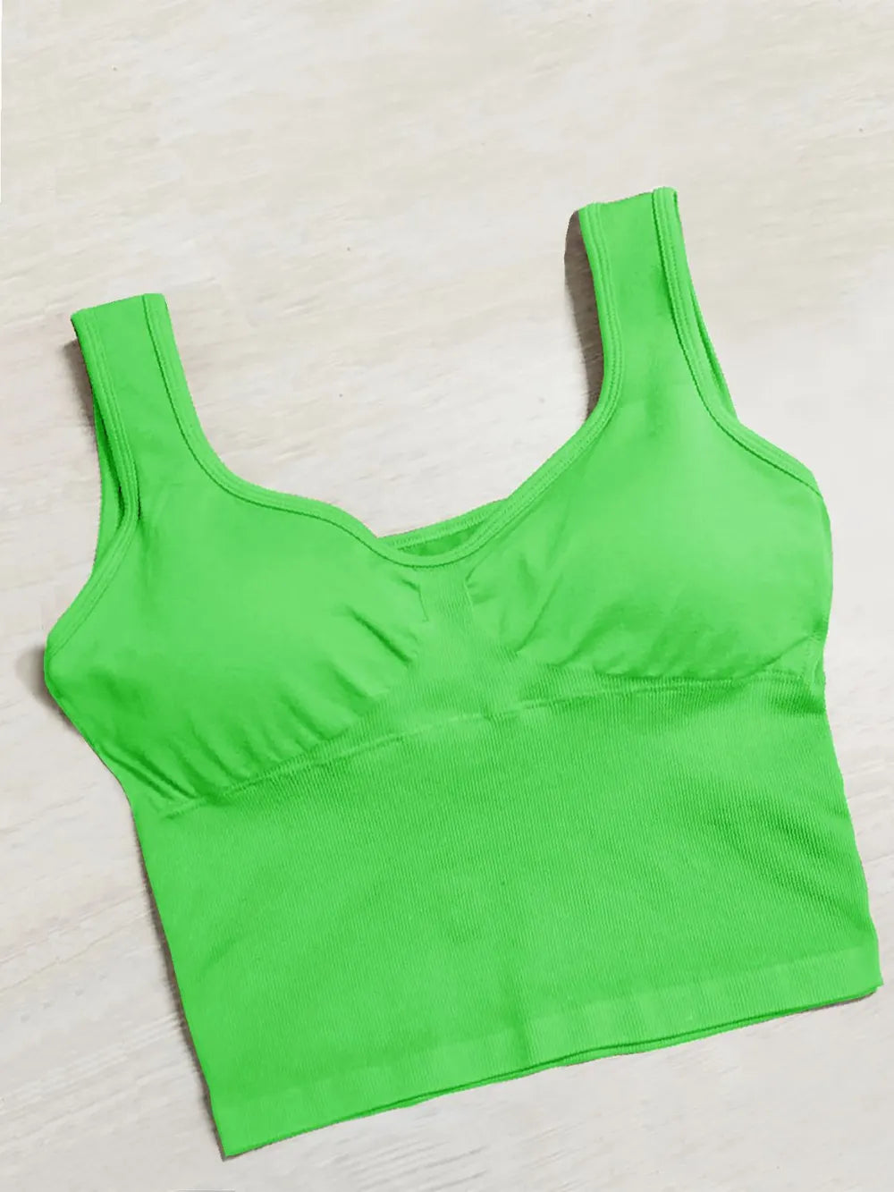 Active tank top in neon green with wide straps and scoop neck, gathered bust
