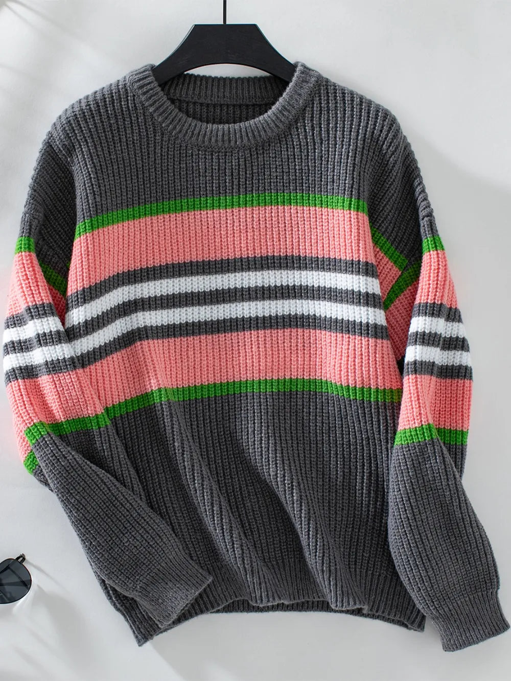 Dark gray round-neck sweater with red, green, and white horizontal stripe bands, long sleeves