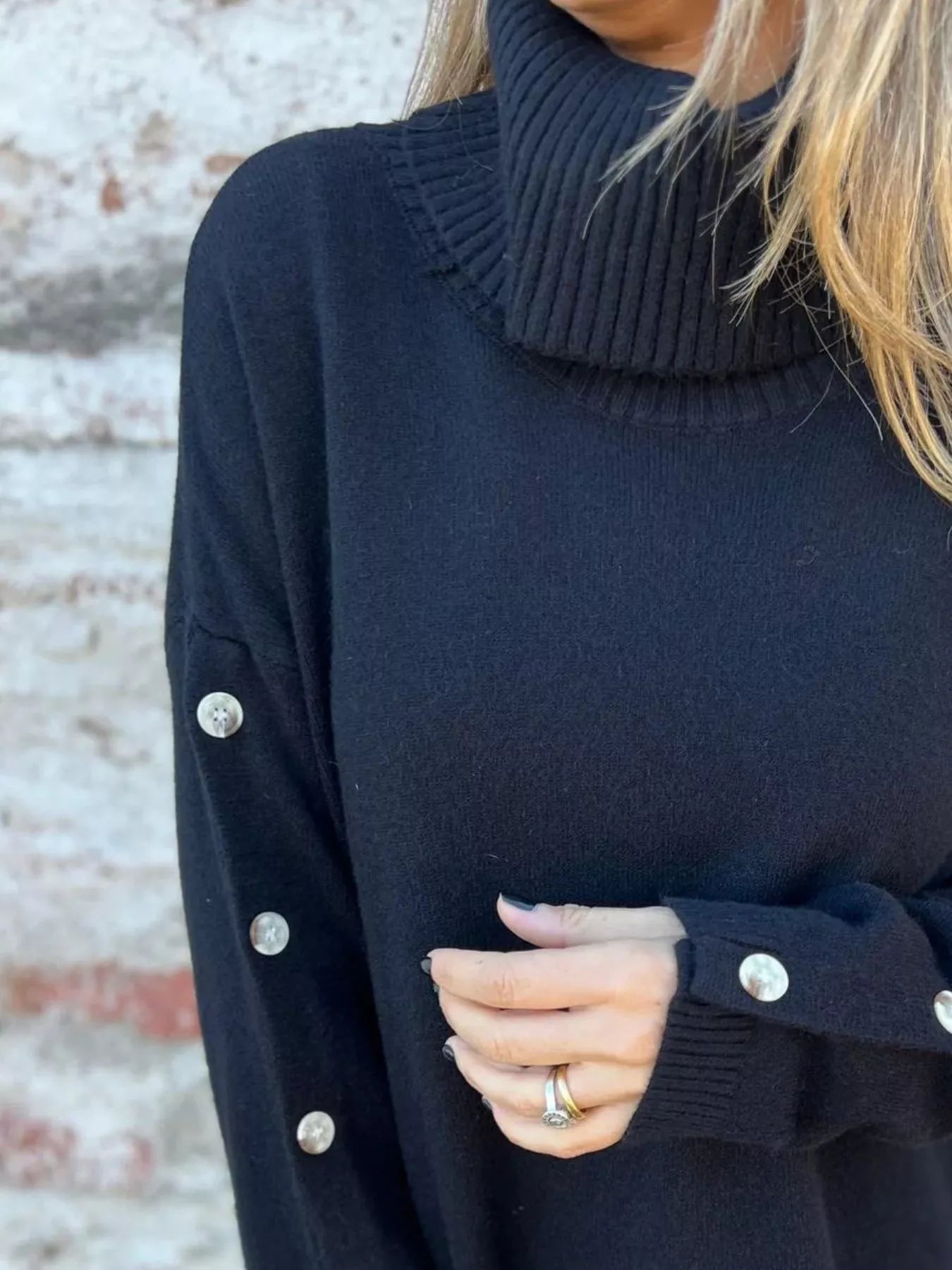 Dark navy turtleneck sweater, long sleeves with buttoned cuffs