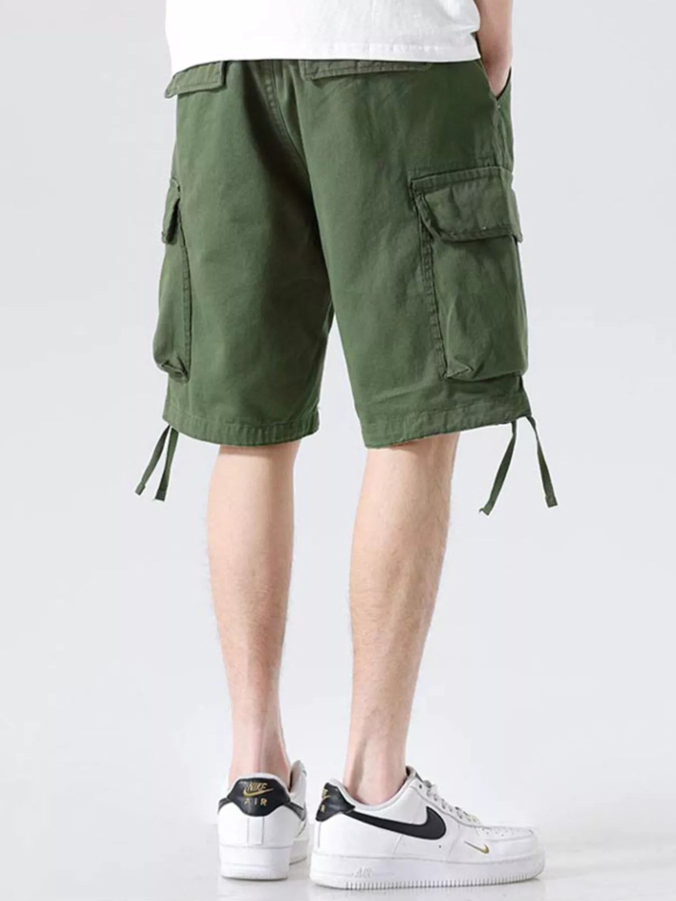 Military green cargo shorts with side cargo pockets, drawstring ties at hem, loose fit