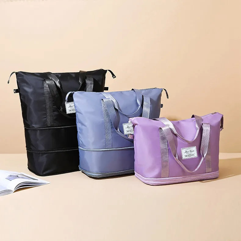 Set of three duffle bags in black, light blue, and lavender with top handles
