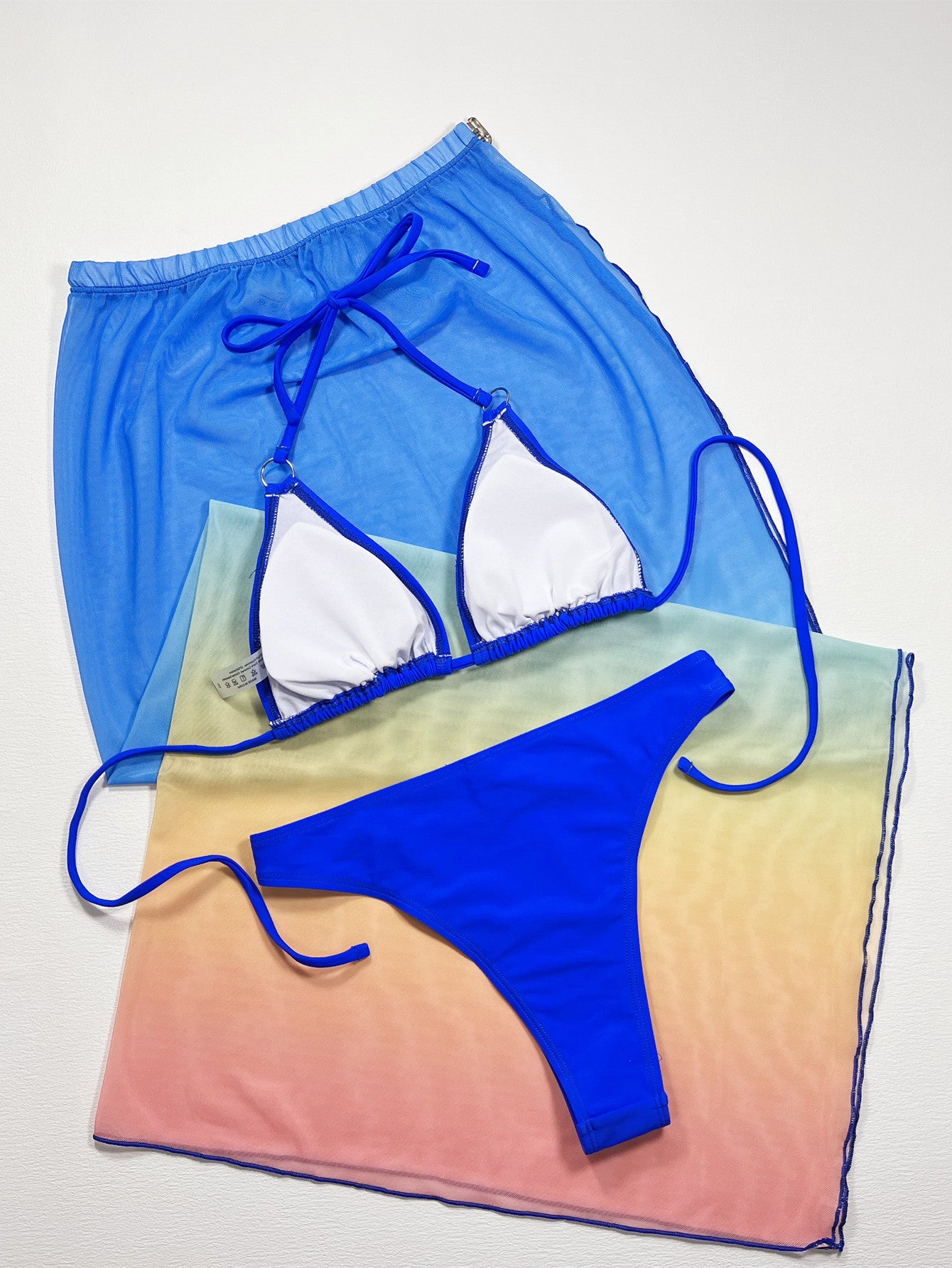 Royal blue triangle bikini top and high-cut bottom with long sheer wrap
