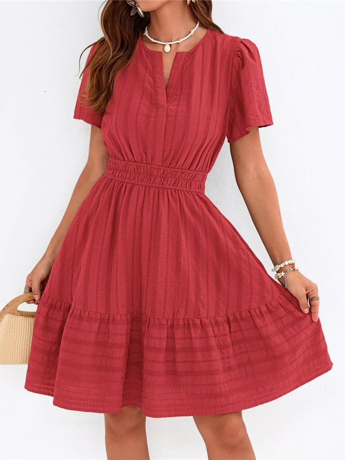 Red short-sleeve smocked-waist tiered dress with V-neck and ruffled hem.