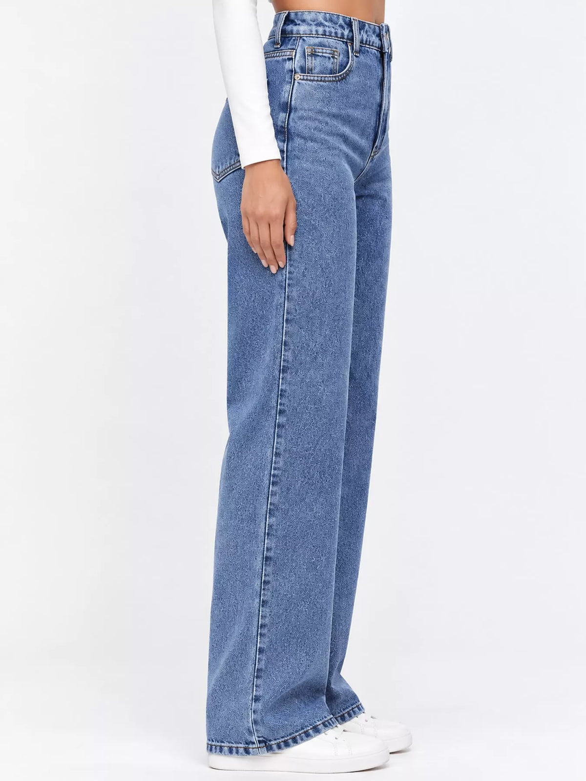 High-waisted vintage wash denim jeans shown from side with wide straight leg