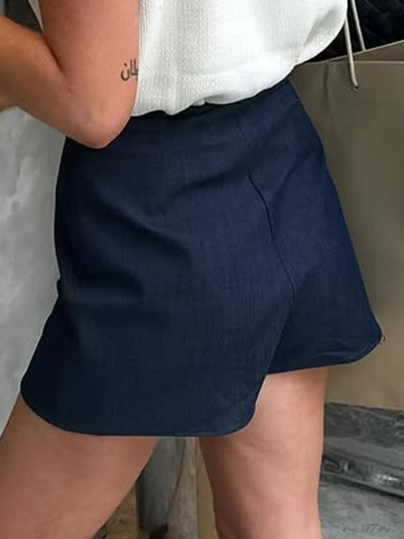 Navy mini skort with curved hem and front slit